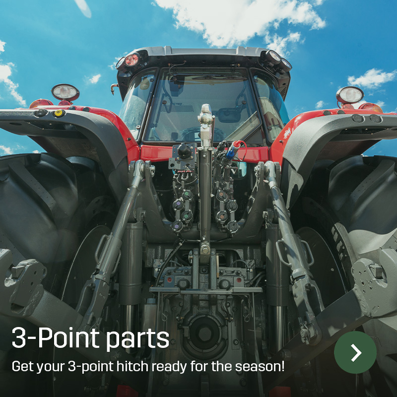 Close-up of a tractor’s rear three-point linkage with lift arms and hydraulic outlets, photographed from the front against the sky. Sagros spare and wear parts are used to keep the three-point hitch ready for implements and daily farm work.