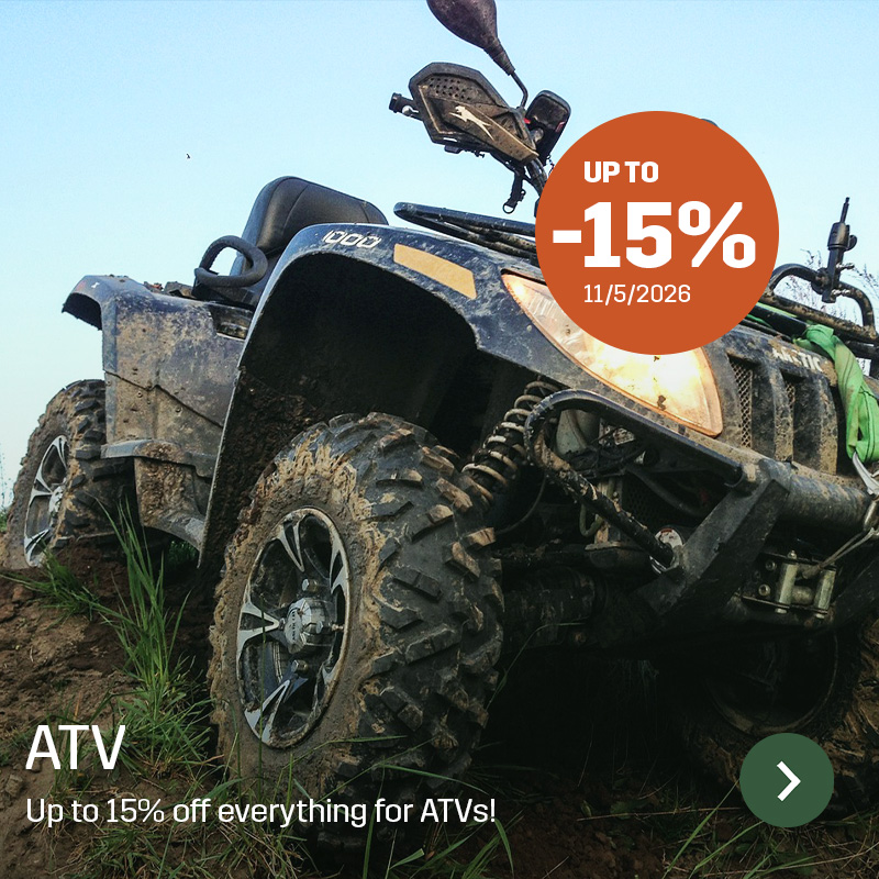 ATV driving in muddy terrain with visible tire tread and suspension in close-up. Sagros range for ATVs is used for work in rough terrain and transport on farms and land.