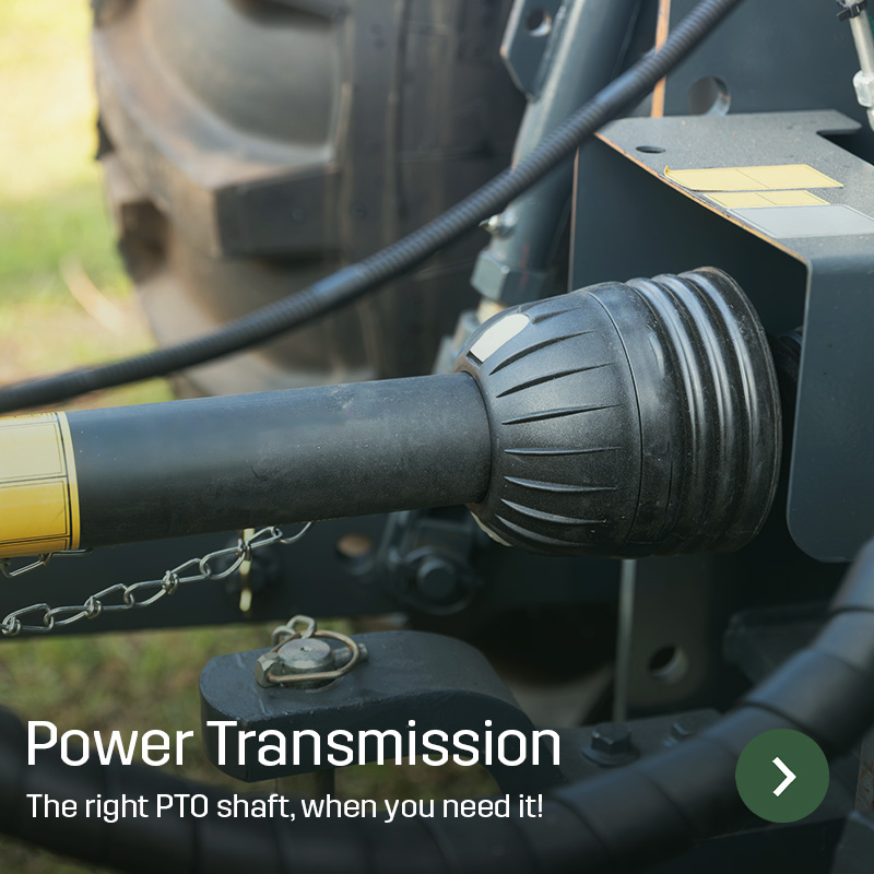 Close-up of a PTO shaft connected between tractor and implement, with protective cover and coupling visible. Sagros spare part is used to transfer power between machines during agricultural work.