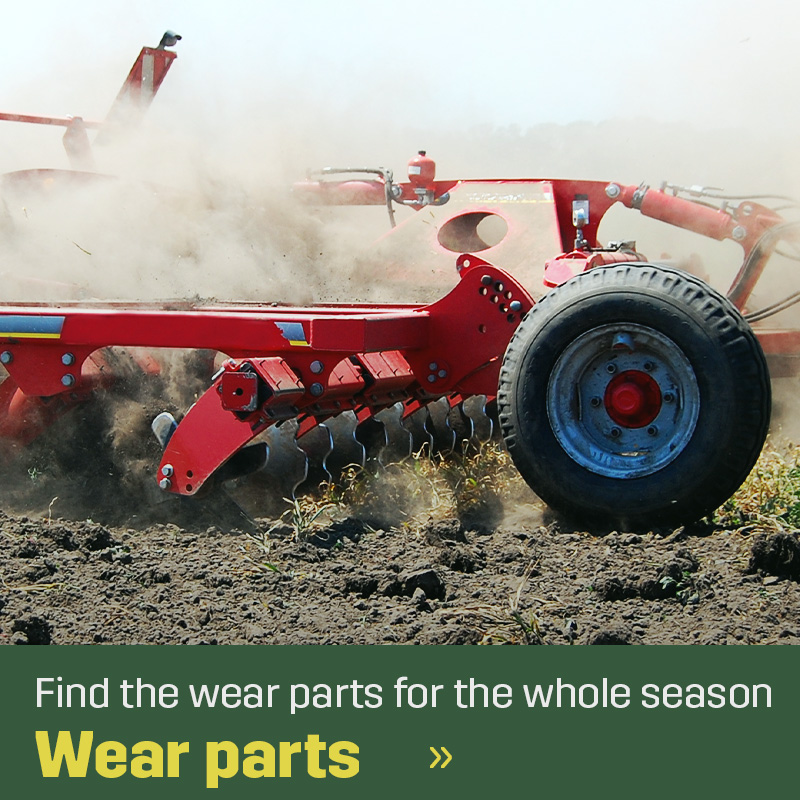 Red soil cultivation implement with discs working through the ground and breaking up crop residue in dusty conditions. Sagros wear parts for soil cultivation machinery are used where the implement meets the soil.