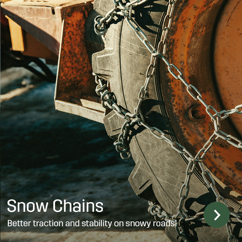 Close-up of snow chains fitted to a tractor tyre with an orange rim. The chains cross the tyre tread to improve traction on snow and ice. Sagros range includes snow chains for agricultural machinery.
